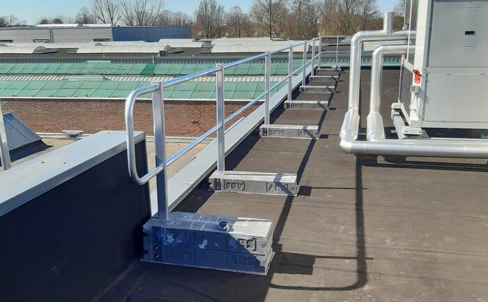 Application photo of a fully assembled guard rail system on a flat roof.